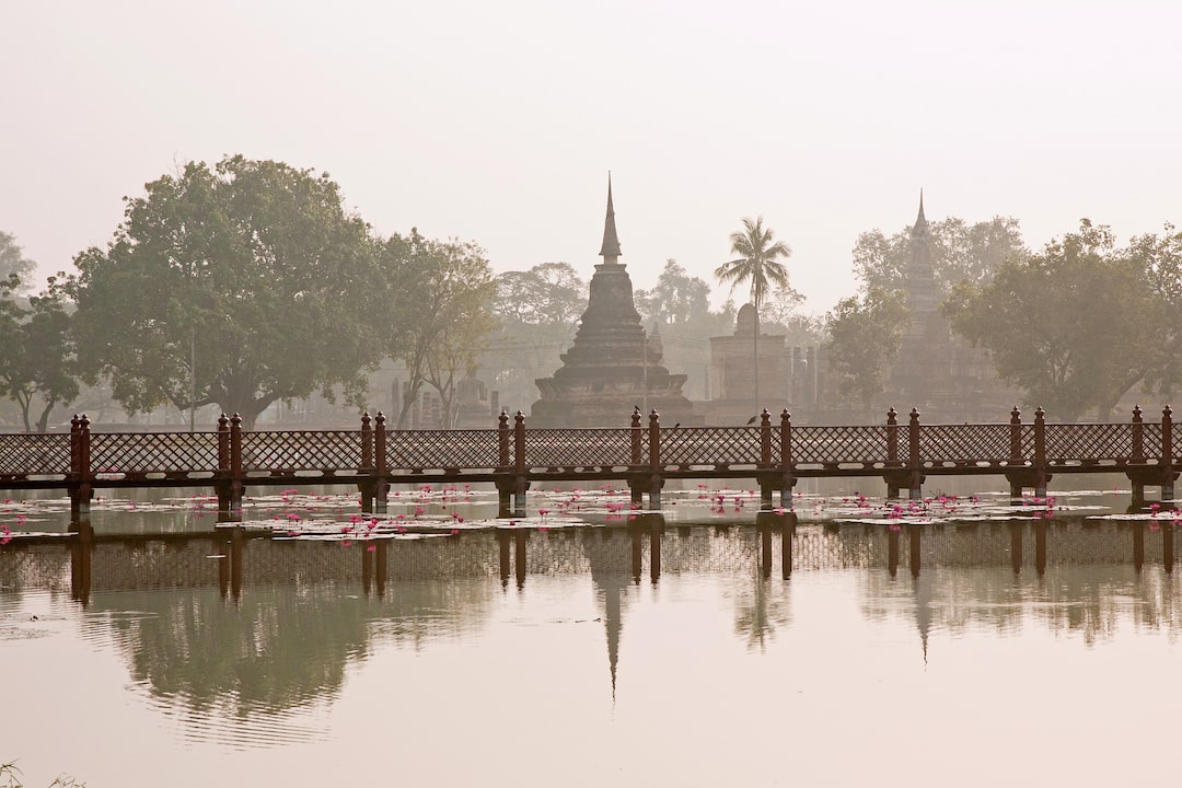 A temple reflecting on the water at dawn at Sukhothai Historical Park
