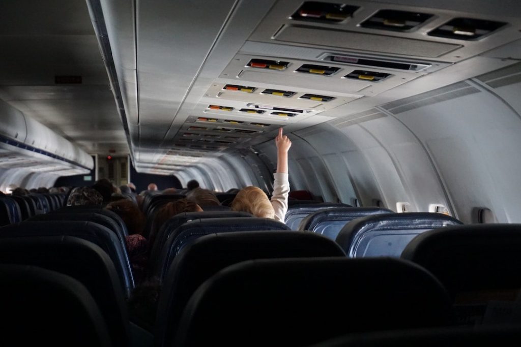 A young child pressing a button on a plane