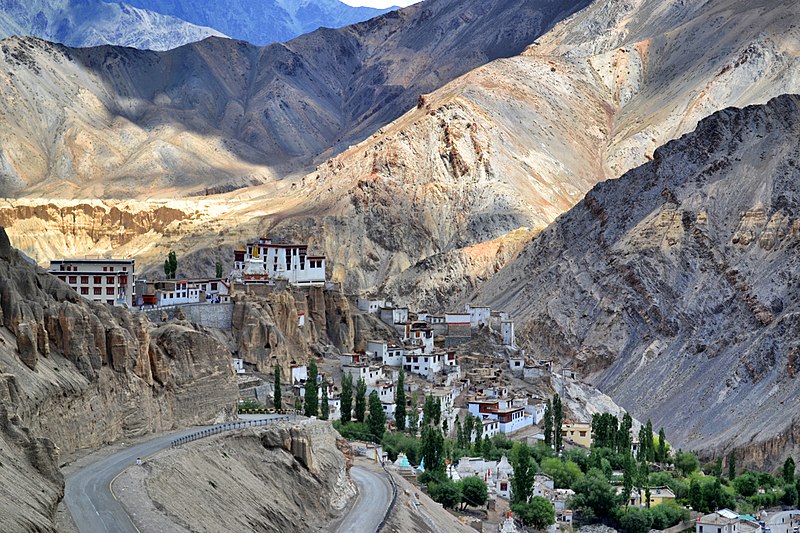 a white monastery in a rocky valley