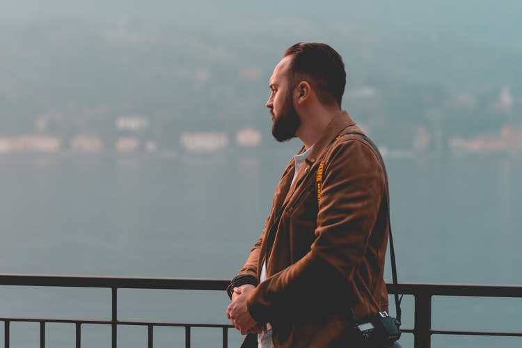 man standing in front of black hand rail in Bellagio Italy