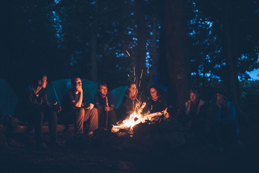 A group of friends sitting around a fire