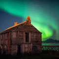 The northern lights over an abandoned barn in Hovden, Norway