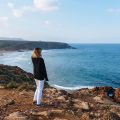 A woman standing looking out onto the ocean in Morocco