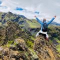 A woman sitting on the top of a cliff in Iceland