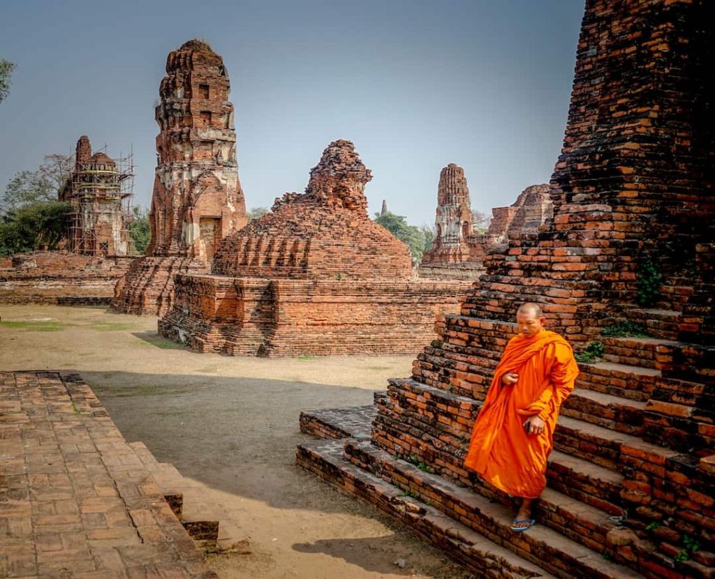 A monk walking down a temple in Ayutthaya, Thailand