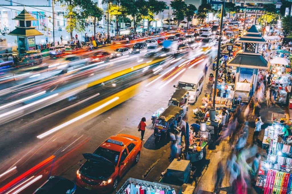 Traffic and people walking on a street in Bangkok