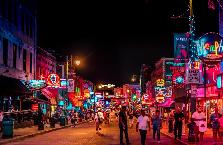 road with buildings and crowding people and neon signs