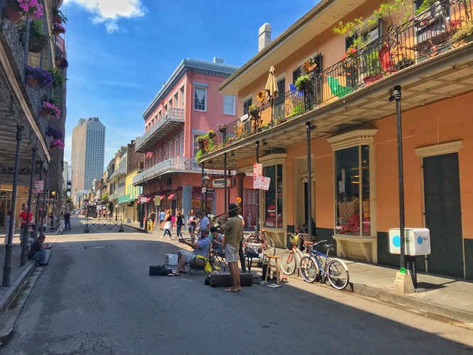 colourful buildings on a street with musicians