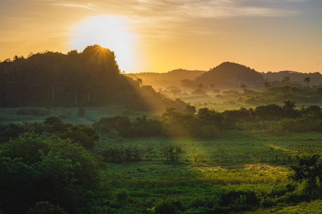 The sun setting over a valley in Vinales, Cuba