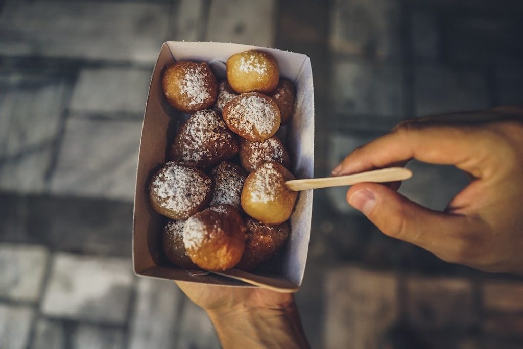 Person holding a container with traditional Greek sweets in Athens