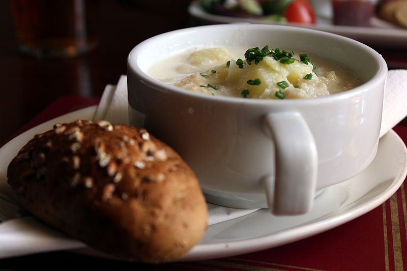 A bowl of cullen skink and a bread roll at a restaurant in Scotland