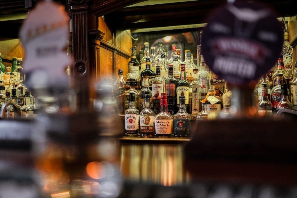 Bottles of whisky on a shelf in a pub in Edinburgh, Scotland