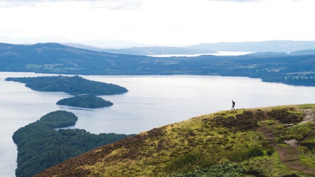 Aerial view of a hiker and Loch Lomond, Scottish Highlands, Scotland