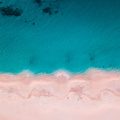 Aerial photo of the ocean meeting the sand on a beach in Australia