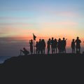 Group of people taking photos at sunset