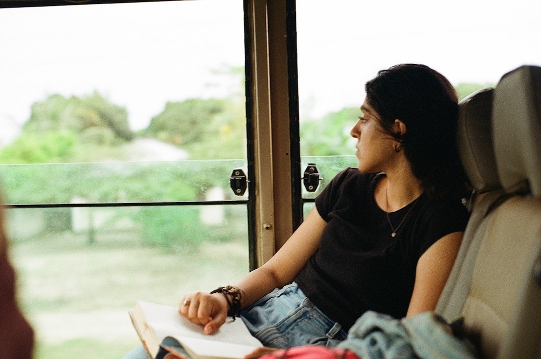 Woman on a bus looking out the window in East Africa
