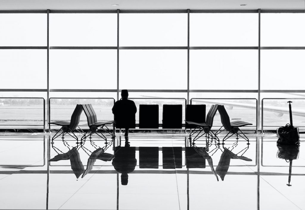 Man sitting alone in empty airport