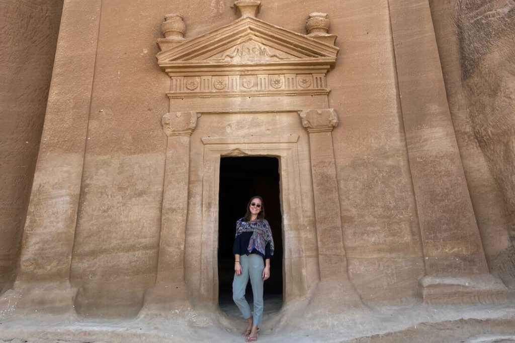 Woman smiling at Hegra in AlUla, Saudi Arabia