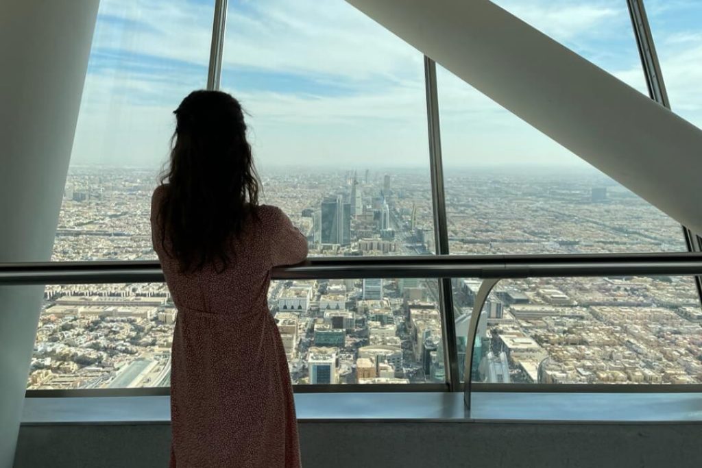 A woman looking down from the Sky Bridge at Kingdom Center in Riyadh, Saudi Arabia