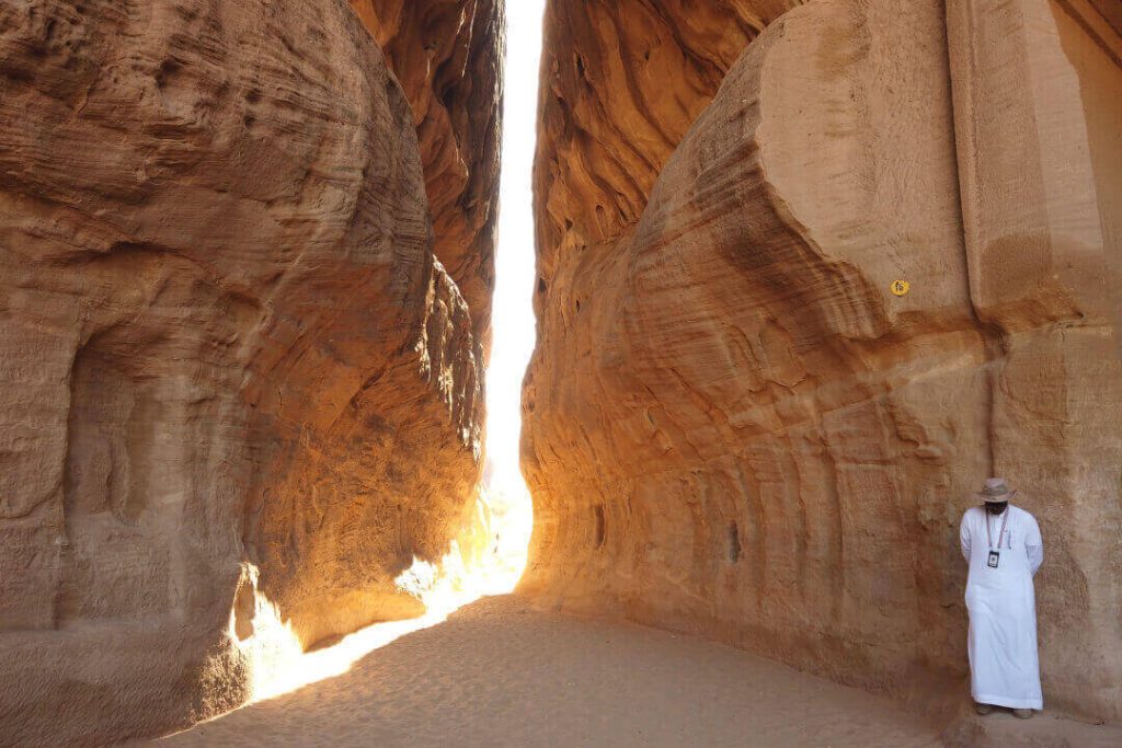 A man in a white robe at Hegra in AlUla, Saudi Arabia