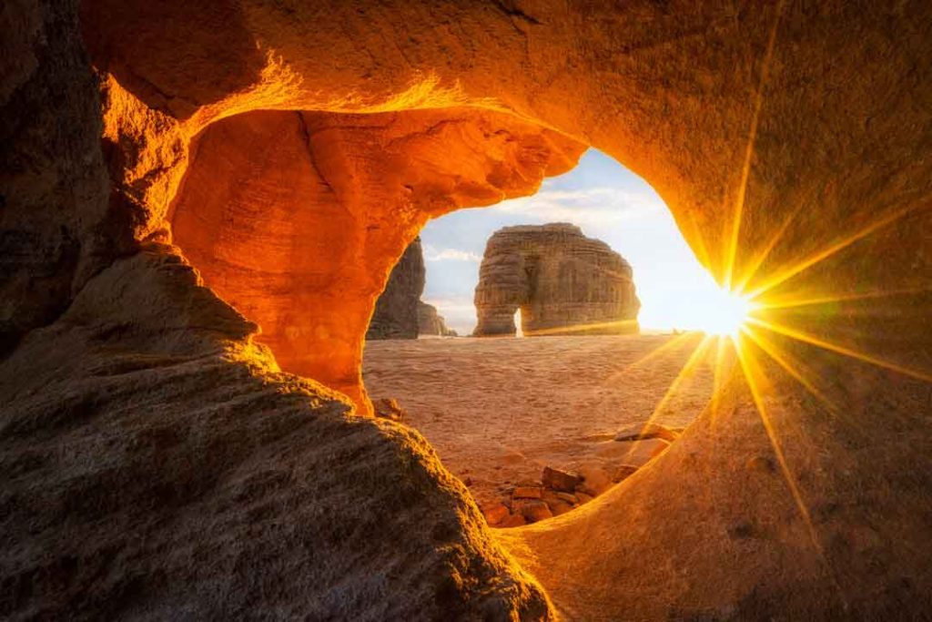 The golden sun shining on Elephant Rock in AlUla, Saudi Arabia.