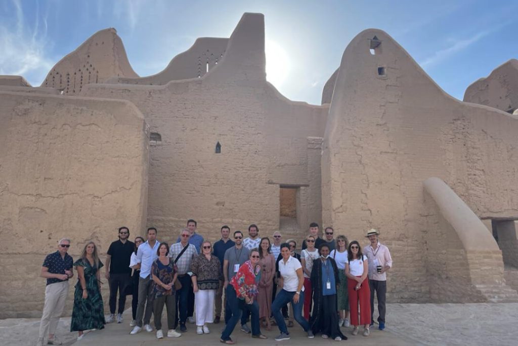 Image showing a group of tourist and their tour guide in Saudi Arabia.